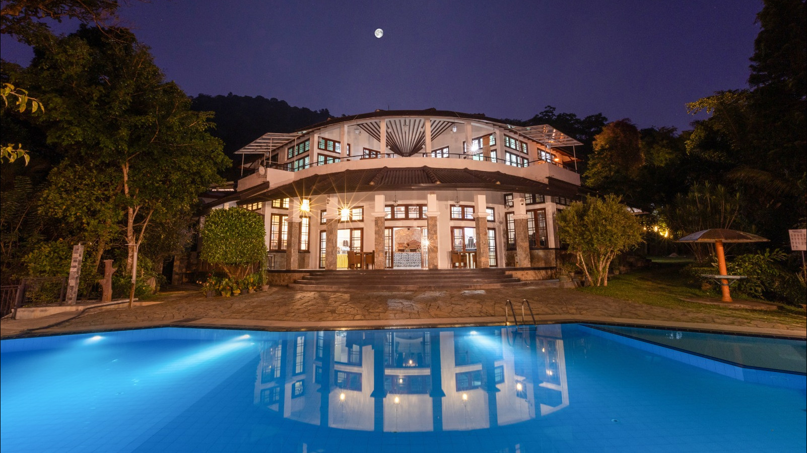 Pool reflecting the villa at night