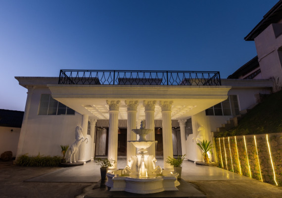 Grand entrance with fountain at night